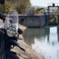 Royal Enfield Himalayan 450 Mana Black parked by a reservoir in Romania after its first 200 km