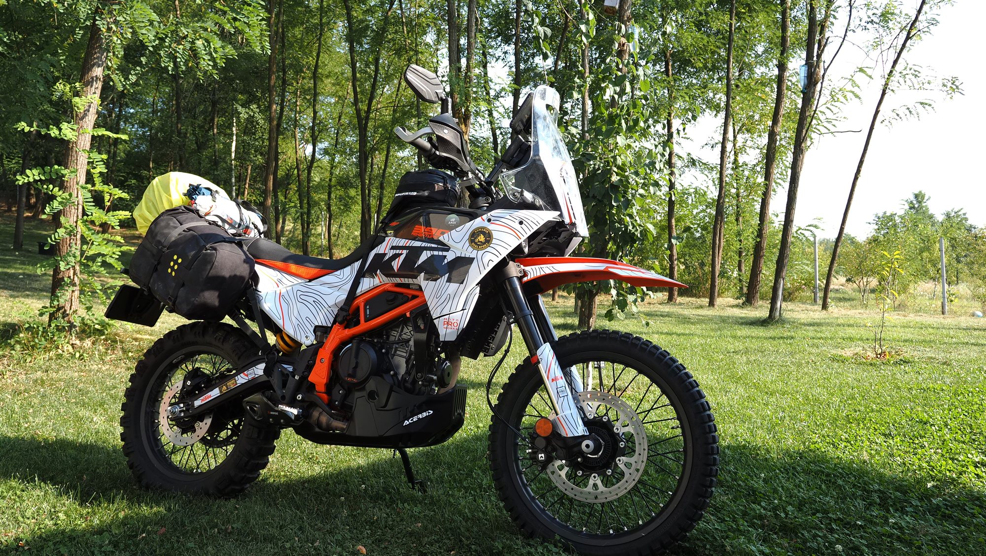 KTM 390 Adventure R loaded with luggage in a forest
